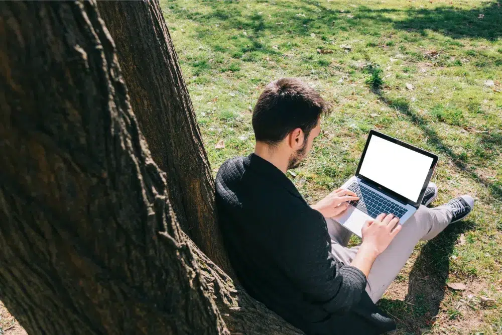 a man using a pc next to a tree and he is conducting a stump removal cost to estimate how much he would spend on his green space a man using a pc next to a tree and he is conducting a stump removal cost to estimate how much he would spend on his green space