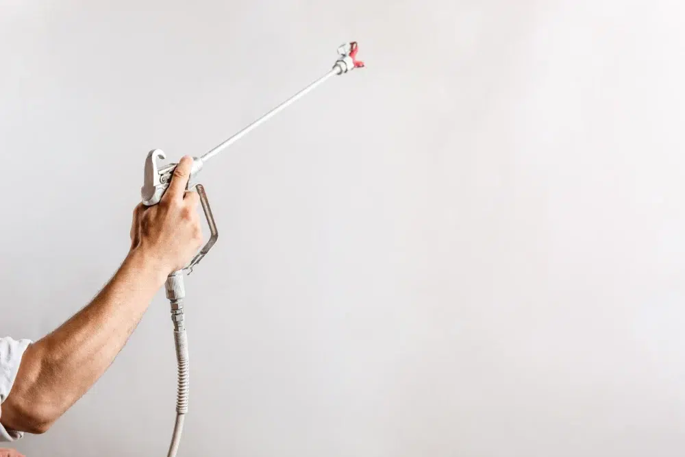Home Maintenance Ideas Every Homeowner Should Consider 2 worker painting wall with spray gun white color home maintenance