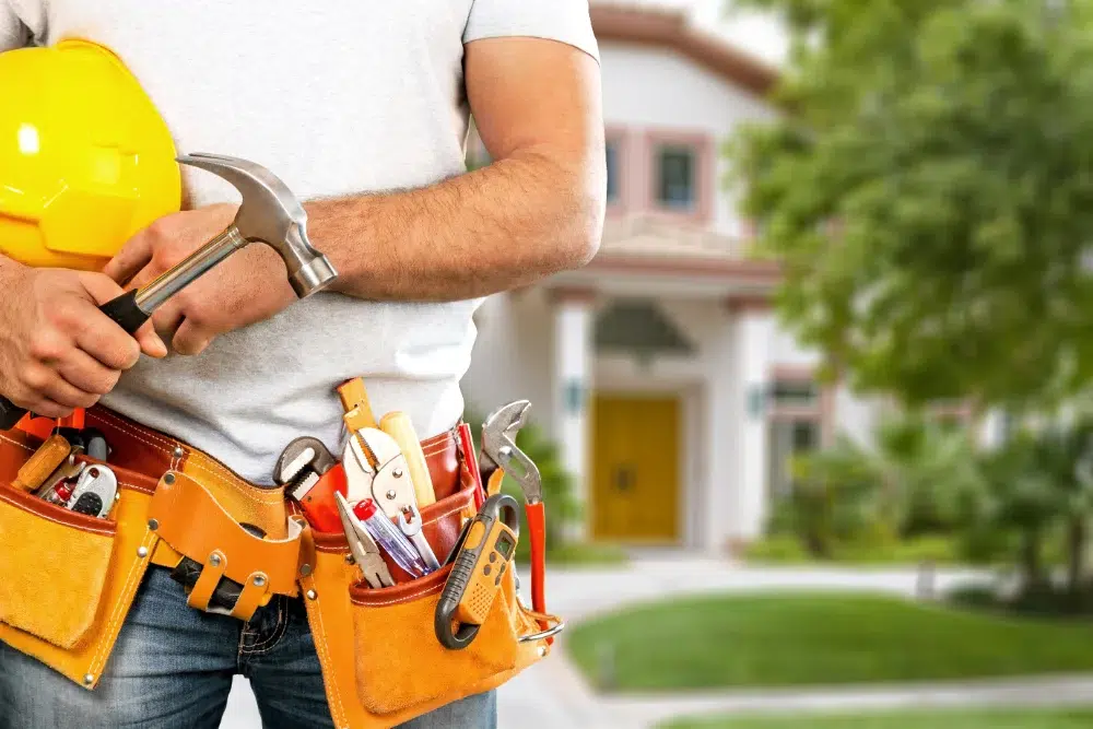 Home Maintenance Ideas Every Homeowner Should Consider 1 young man worker with tool belt helmet home maintenance